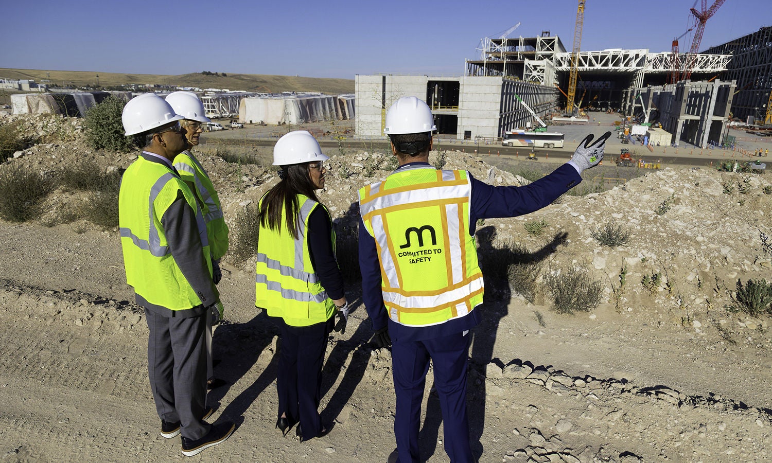 A group of people wearing safety vests and helmets at a Micron expansion location​
